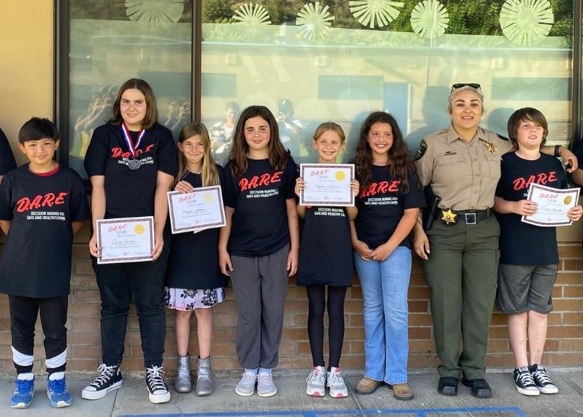 Detective Bolanos with some 2023 D.A.R.E. graduates.